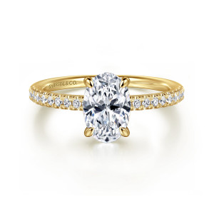Gabriel & Co. ER16058O6Y44JJ 14 karat yellow gold Classic engagement ring, front view of an oval center with slender prongs and diamonds set along both shoulders