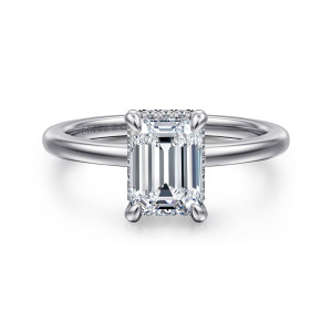 Gabriel & Co. ER16061E6W44JJ 14 karat white gold Classic engagement ring, front view of an emerald cut center in four claws with tiny diamonds just showing at its edges