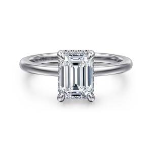 Gabriel & Co. ER16061E6W84JJ 18 karat white gold Classic engagement ring, front view of an emerald cut center in corner claws, with tiny diamonds just peeking out below it