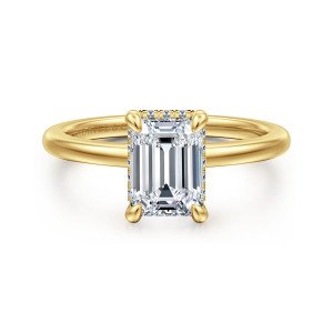 Gabriel & Co. ER16061E6Y44JJ 14 karat yellow gold Classic engagement ring, front view of an emerald cut center with four prongs and tiny diamonds peeking out around its edge