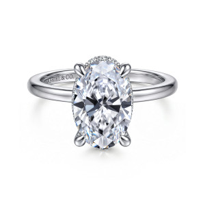Gabriel & Co. ER16061O12W44JJ 14 karat white gold Classic engagement ring, front view of an oval center on four claws with a thin sliver of stones showing behind