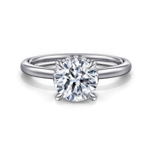 Gabriel & Co. ER16061R6W44JJ 14 karat white gold Classic engagement ring, front view of a round center in four rounded prongs with tiny diamonds glimpsed behind it