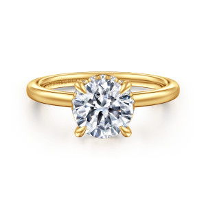Gabriel & Co. ER16061R6Y84JJ 18 karat yellow gold Classic engagement ring, front view of a round center with four tapered prongs and tiny diamonds glinting at its rim