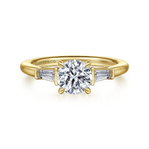 Gabriel & Co. ER16121R4Y43JJ 14 karat yellow gold Classic engagement ring, front view of the round center between two tapered baguettes closed in by end bars