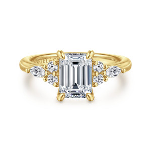 Gabriel & Co. ER16125E6Y44JJ 14 karat yellow gold Contemporary engagement ring, front view of an emerald cut center with two round diamonds and an elongated stone on each side