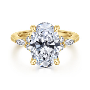 Gabriel & Co. ER16125O16Y44JJ 14 karat yellow gold Contemporary engagement ring, front view of the oval center with a round and elongated stone cluster on each side
