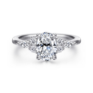 Gabriel & Co. ER16125O4PT4JJ platinum Contemporary engagement ring, front view of an oval center flanked by round and elongated pointed diamonds in beaded clusters
