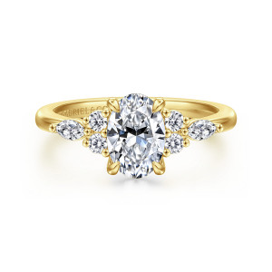 Gabriel & Co. ER16125O4Y44JJ 14 karat yellow gold Contemporary engagement ring, front view of paired round diamonds and an elongated stone on each side of an oval center