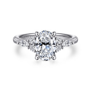 Gabriel & Co. ER16125O6W44JJ 14 karat white gold Contemporary engagement ring, front view of an oval center in four claws with a cluster of diamonds on each shoulder