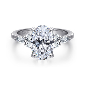 Gabriel & Co. ER16125O8W44JJ 14 karat white gold Contemporary engagement ring, front view of an oval center flanked by round diamonds and an elongated stone each side