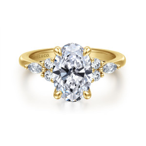 Gabriel & Co. ER16125O8Y44JJ 14 karat yellow gold Contemporary engagement ring, front view of a tall oval center with two round diamonds and an elongated stone on each shoulder