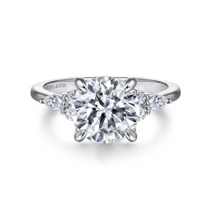 Gabriel & Co. ER16125R12W44JJ 14 karat white gold Contemporary engagement ring, front view of the large round center hugged by two small clusters of round and elongated stones