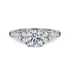 Gabriel & Co. ER16125R4W44JJ 14 karat white gold Contemporary engagement ring, front view of a round center with a cluster of round and elongated stones on each shoulder