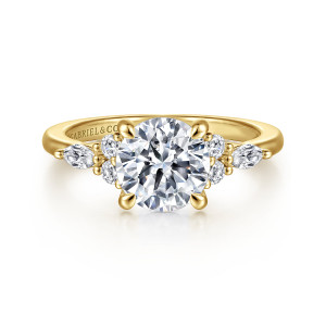 Gabriel & Co. ER16125R6Y44JJ 14 karat yellow gold Contemporary engagement ring, front view of a round center held by rounded tip prongs, with stone groups reaching along the band