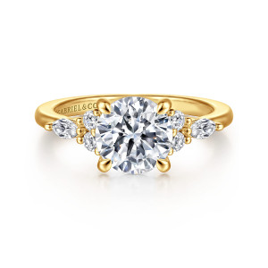 Gabriel & Co. ER16125R6Y84JJ 18 karat yellow gold Contemporary engagement ring, front view of a round center between two shoulder clusters of round and elongated diamonds