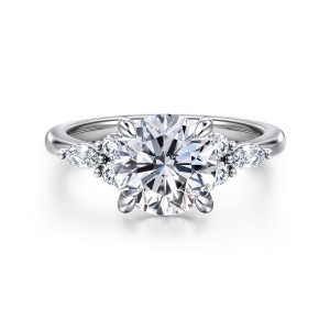 Gabriel & Co. ER16125R8W44JJ 14 karat white gold Contemporary engagement ring, front view of a round center with paired round stones and an elongated stone at each side