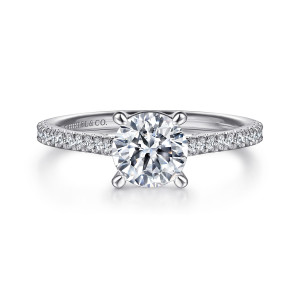 Gabriel & Co. ER16129R4W44JJ 14 karat white gold Contemporary engagement ring, front view of a round center on four prongs with pave diamonds beginning at its base