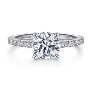 Gabriel & Co. ER16129R8W44JJ 14 karat white gold Contemporary engagement ring, front view of a round center on four rounded prongs with pave diamonds tapering along both shoulders