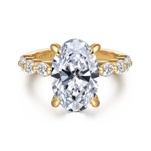 Gabriel & Co. ER16130O16Y44JJ 14 karat yellow gold Classic engagement ring, front view of an oval center between round diamonds spaced along both shoulders
