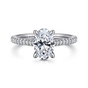 Gabriel & Co. ER16131O6W44JJ 14 karat white gold Classic engagement ring, front view of an oval center with clean claw tips and a band of notched pave stones