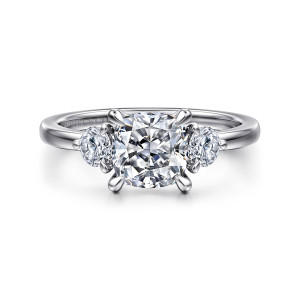 Gabriel & Co. ER16136C6W44JJ 14 karat white gold Contemporary engagement ring, front view of a cushion cut center between two round side diamonds on a smooth band