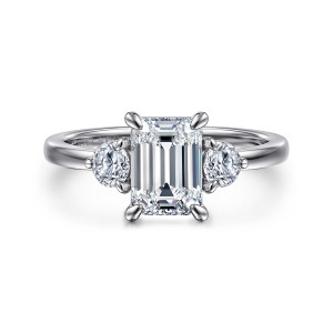 Gabriel & Co. ER16136E6W44JJ 14 karat white gold Contemporary engagement ring, front view of an emerald cut center between two round side diamonds on a smooth band