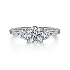 Gabriel & Co. ER16136R4W44JJ 14 karat white gold Contemporary engagement ring, front view of a round center in four claws between two smaller stones on a smooth band