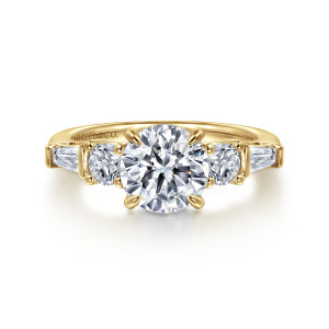 Gabriel & Co. ER16179R6Y44JJ 14 karat yellow gold Contemporary engagement ring, front view of a round center with a round stone and a tapered baguette stepping down each side