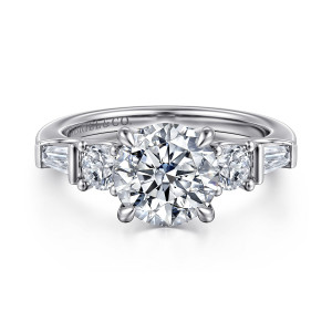 Gabriel & Co. ER16179R8W44JJ 14 karat white gold Contemporary engagement ring, front view of a round center flanked by round stones and tapered baguettes