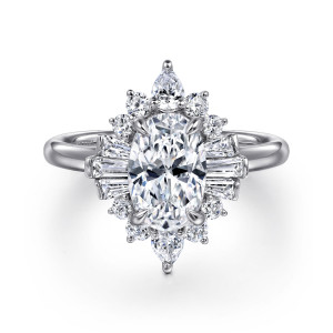 Gabriel & Co. ER16185O6W44JJ 14 karat white gold Starlight engagement ring, front view of an oval center framed by pointed tips and tapered baguettes at each side