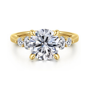 Gabriel & Co. ER16192R12Y44JJ 14 karat yellow gold Classic engagement ring, front view of the round center between two small stones on each shoulder with beads between them