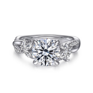 Gabriel & Co. ER16196R8W44JJ 14 karat white gold Floral Nouveau engagement ring, front view of a round center between two fanned clusters of elongated diamonds