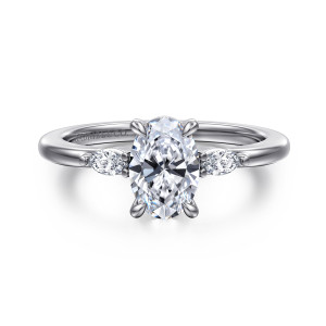 Gabriel & Co. ER16198O4W43JJ 14 karat white gold Classic engagement ring, front view of the oval center between two small elongated side stones with bead accents
