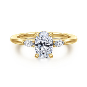 Gabriel & Co. ER16198O4Y43JJ 14 karat yellow gold Classic engagement ring, front view of the oval center held by four tapered prongs with small stones at each side
