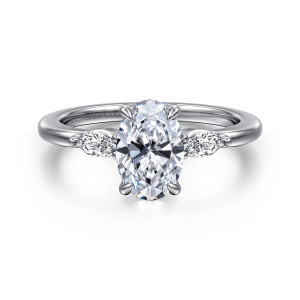 Gabriel & Co. ER16198O6W43JJ 14 karat white gold Classic engagement ring, front view of an oval center between two elongated shoulder diamonds and four prongs