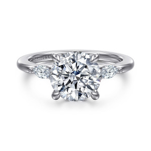 Gabriel & Co. ER16198R10W43JJ 14 karat white gold Classic engagement ring, front view of a round center flanked by two elongated side diamonds on a slim band