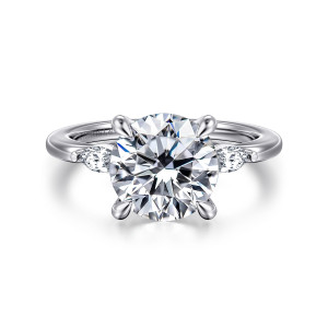 Gabriel & Co. ER16198R12W43JJ 14 karat white gold Classic engagement ring, front view of a round center flanked by small elongated diamonds on a smooth polished band