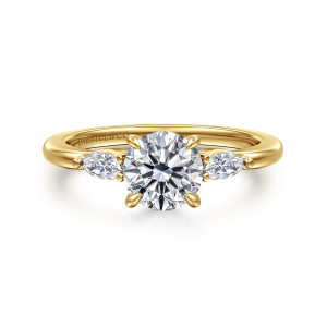 Gabriel & Co. ER16198R4Y43JJ 14 karat yellow gold Classic engagement ring, front view of the round center with an elongated diamond on either side