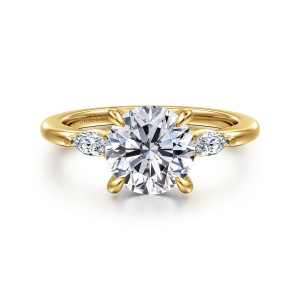 Gabriel & Co. ER16198R8Y43JJ 14 karat yellow gold Classic engagement ring, front view of a round center flanked by two small elongated stones on a smooth band
