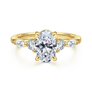 Gabriel & Co. ER16199O6Y44JJ 14 karat yellow gold Contemporary engagement ring, front view of an oval center flanked by a round stone and an elongated stone on each side