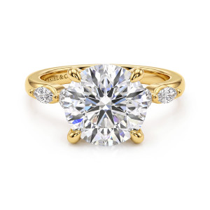 Gabriel & Co. ER16199R16Y44JJ 14 karat yellow gold Contemporary engagement ring, front view of a round center in four rounded prongs with elongated stones at the shoulders