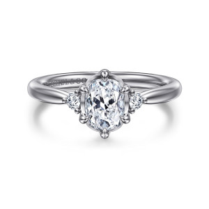 Gabriel & Co. ER16200G6W44JJ 14 karat white gold Contemporary engagement ring, front view of an elongated center ringed by slender prongs with a small round diamond on each side