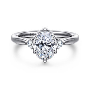 Gabriel & Co. ER16200O4W44JJ 14 karat white gold Contemporary engagement ring, front view of an oval center in flared prongs with a small round diamond at each side