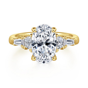 Gabriel & Co. ER16217O12Y43JJ 14 karat yellow gold Classic engagement ring, front view of an oval center between step cut stones and tapered baguettes on a plain band