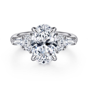 Gabriel & Co. ER16219O12W43JJ 14 karat white gold Classic engagement ring, front view of an oval center flanked by half moon and tapered baguette side stones