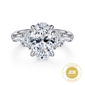Gabriel & Co. ER16219O12W83JJ 18 karat white gold Classic engagement ring, front view of an oval center with half moon stones and tapered baguettes on both shoulders
