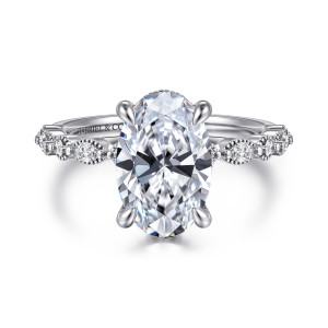 Gabriel & Co. ER16233O12W44JJ 14 karat white gold Victorian engagement ring, front view of the oval center with round and elongated stones in beaded edges on the band
