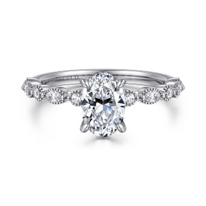 Gabriel & Co. ER16233O4W44JJ 14 karat white gold Victorian engagement ring, front view of an oval center with alternating round and elongated diamonds in beaded rims on both shoulders