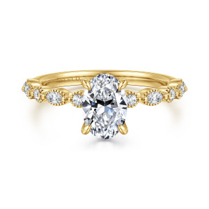 Gabriel & Co. ER16233O4Y44JJ 14 karat yellow gold Victorian engagement ring, front view of an oval center in four claws, flanked by beaded round and elongated stones