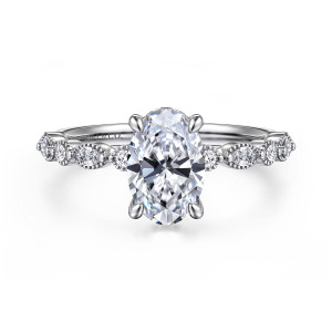 Gabriel & Co. ER16233O6W44JJ 14 karat white gold Victorian engagement ring, front view of the oval seat flanked by round and elongated diamonds in beaded rims